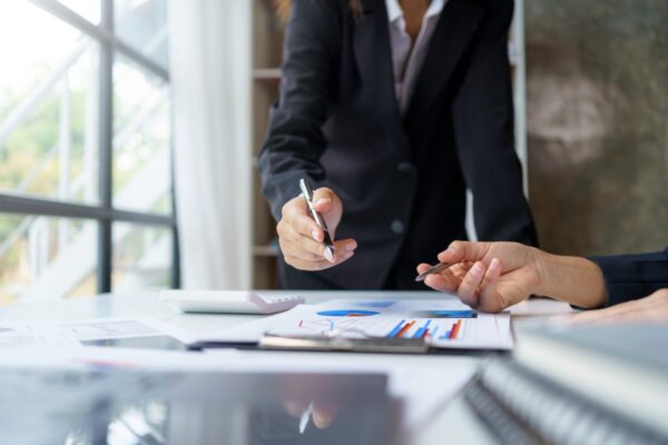 Business people analyzes, graphs and charts to examine and analyze company finances, revenues